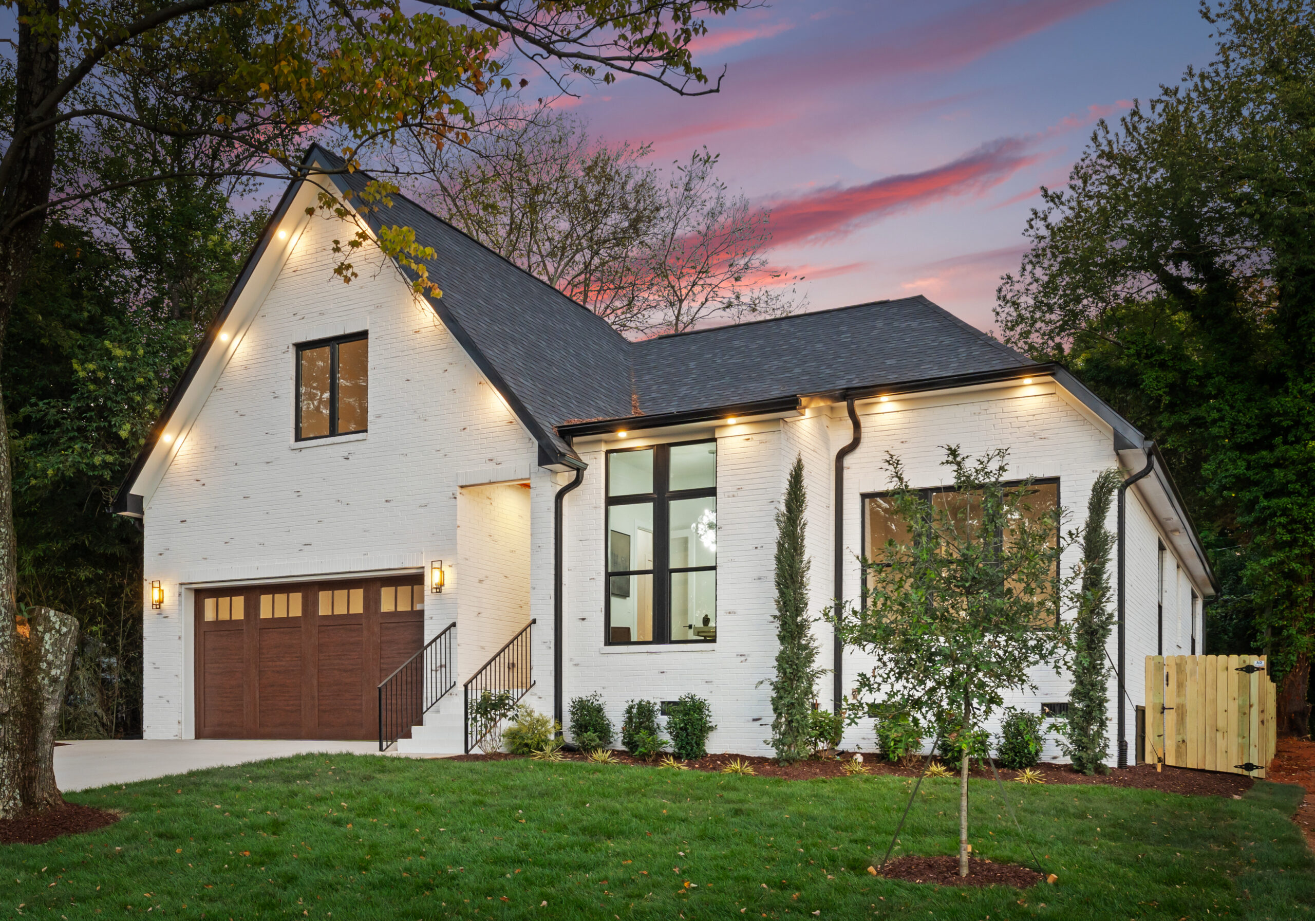 Front elevation at twilight with a landscaped lawn