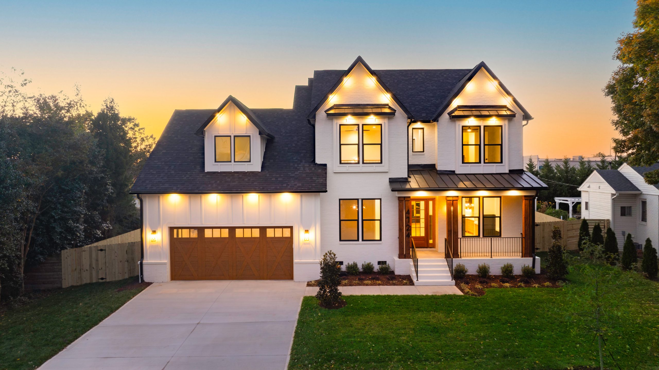 Two-story Northway Signature Series home with warm exterior lighting at dusk